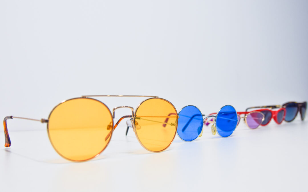 Line of sunglasses of varying colours and shades.