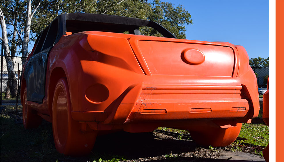 orange plastic car target (prototype) on site